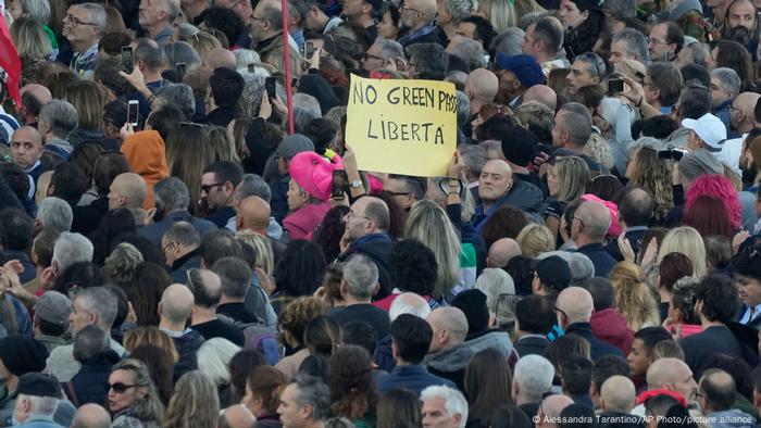 A demonstrator holds a banner reading No Green Pass, freedom during a protest at Rome's Circus Maximus