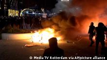In this image taken from video, demonstrators protest against government restrictions due to the coronavirus pandemic, Friday, Nov. 19, 2021, in Rotterdam, Netherlands. Police fired warning shots, injuring an unknown number of people, as riots broke out Friday night in downtown Rotterdam at a demonstration against plans by the government to restrict access for unvaccinated people to some venues. (Media TV Rotterdam via AP)