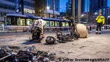 This photograph taken on November 20, 2021 shows a burned electric scooter after a protest against the partial lockdown and against the 2G government policy in Rotterdam. - Dutch police fired warning shots, injuring at least two people, after rioters against a partial Covid lockdown torched a police car and hurled stones in Rotterdam on November 19, 2021. Chaos broke out after a protest in the port city against the coronavirus restrictions and government plans to restrict access for unvaccinated people to some venues. (Photo by Jeffrey Groeneweg / ANP / AFP) / Netherlands OUT
