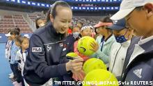 Chinese tennis player Peng Shuai signs large-sized tennis balls at the opening ceremony of Fila Kids Junior Tennis Challenger Final in Beijing, China November 21, 2021, in this screen grab obtained from a social media video. TWITTER @QINGQINGPARIS via REUTERS THIS IMAGE HAS BEEN SUPPLIED BY A THIRD PARTY. MANDATORY CREDIT. NO RESALES. NO ARCHIVES.