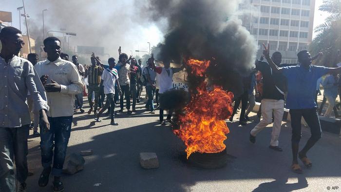 Sudanese protesters burn tires as they rally on a street in the capital Khartoum