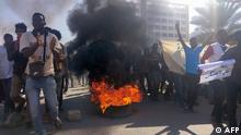 Sudanese protesters burn tyres as they rally on a street in the capital Khartoum, on November 21, 2021. - Hundreds of Sudanese protesters again rallied against last month's military coup and the ensuing crackdown which left at least 40 people killed, witnesses said. (Photo by AFP)
