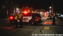 WAUKESHA, WI - NOVEMBER 21: Police and emergency personnel work on a crime scene on November 21, 2021 in Waukesha, Wisconsin. According to reports, an SUV drove through pedestrians at a holiday parade, killing at least one and injuring 20 more. (Photo by Jim Vondruska/Getty Images)