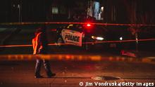 WAUKESHA, WI - NOVEMBER 21: Police and emergency personnel work on a crime scene on November 21, 2021 in Waukesha, Wisconsin. According to reports, an SUV drove through pedestrians at a holiday parade, killing at least one and injuring 20 more. (Photo by Jim Vondruska/Getty Images)