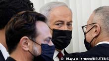 Former Israeli Prime Minister Benjamin Netanyahu flanked by lawyers before testimony by star witness Nir Hefetz, a former aide, in Netanyahu's corruption trial at the District Court in east Jerusalem