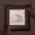 Die Zeichnung "Die Jungfrau und das Kind" hängt in einem quadratischen Bilderrahmen an der Wand, rechts im Bild ist eine Person zu sehen, die das Bild anschaut