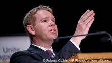 New Zealand's COVID-19 Response Minister Chris Hipkins gestures during a press conference in Wellington, New Zealand, Thursday, Oct. 28, 2021. Hipkins said that from next month, most people arriving in New Zealand would need to spend seven days in a quarantine hotel run by the military, half the previous requirement. (Robert Kitchin/Pool Photo via AP)