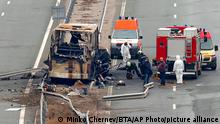 Firefighters and forensic workers inspect the scene of a bus crash on a highway near the village of Bosnek, western Bulgaria, Tuesday, Nov. 23, 2021. A bus carrying tourists back to North Macedonia crashed and caught fire in western Bulgaria early Tuesday, killing at least 45 people, including a dozen children, authorities said. (Minko Chernev/BTA Agency Bulgaria via AP)