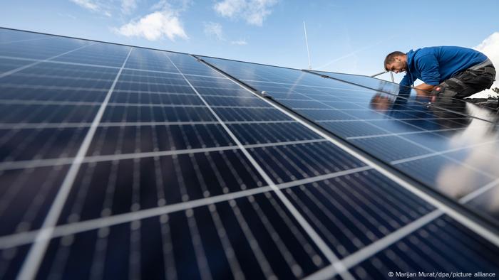 trabajador poniendo paneles solares en el techo