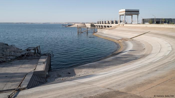 The dry basin rim of Tabqa Dam shows how much the water level of Lake Assad has dropped