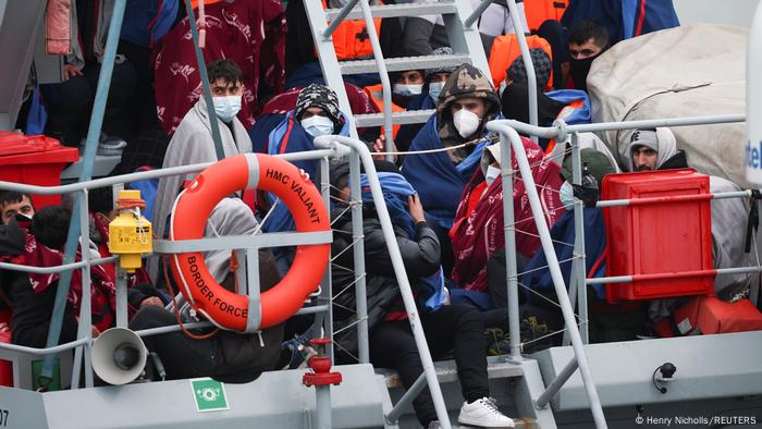 People with face masks on, on a boat People with face masks on, on a boat