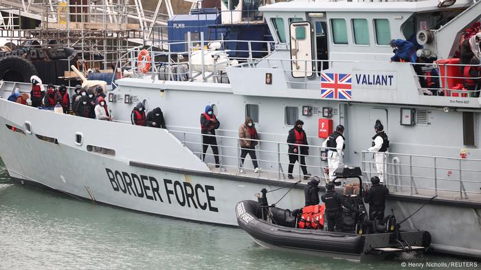 Migrants onboard a Border Force rescue boat line up to disembark at Dover harbour Migrants onboard a Border Force rescue boat line up to disembark at Dover harbour