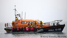 Migrants are escorted ashore by a RNLI Lifeboat, after having crossed the channel, in Dungeness, Britain, November 24, 2021. REUTERS/Henry Nicholls 