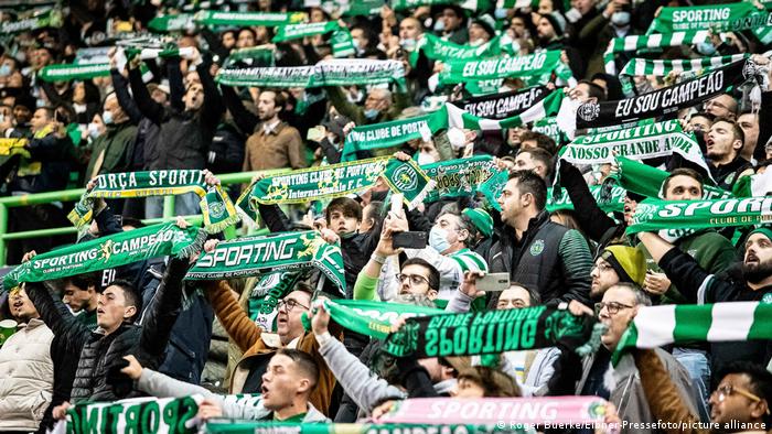 Sporting CP fans hold up scarves ahead of their side's Champions League game against Borussia Dortmund