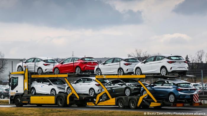  Brand new Opel Astra vehicles are transported by a car carrier trailer as they leave the Opel car factory of General Motors Manufacturing Poland in Gliwice