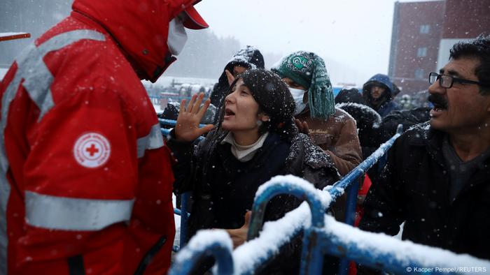 Migrants gather at a transport and logistics center, near the Belarusian-Polish border