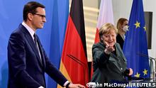 German Chancellor Angela Merkel gestures as she and Polish Prime Minister Mateusz Morawiecki address a joint press conference after talks in Berlin, Germany November 25, 2021. John MacDougall/Pool via REUTERS
