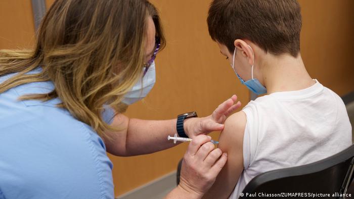 A nurse vaccinates a young boy in Montreal