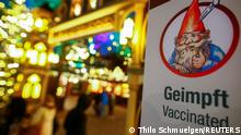 A sign about the '2G' rule, which allows only those vaccinated or recovered from the coronavirus disease (COVID-19) to visit the Christmas markets, is seen in Cologne, Germany, November 22, 2021. REUTERS/Thilo Schmuelgen
