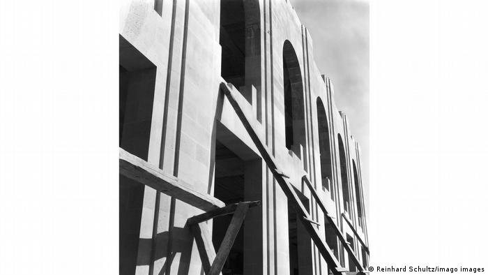 Modotti photograph of scaffolding on the facade of Mexico City Stadium, showing the arched windows of the building in construction.