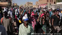 Thousands of protesters take to the streets to renew their demand for a civilian government in the Sudanese capital Khartoum, Thursday, Nov. 25, 2021. The rallies came just days after the military signed a power-sharing deal with the prime minister, after releasing him from house arrest and reinstating him as head of government. The deal came almost a month after the generals orchestrated a coup. Sudan’s key pro-democracy groups and political parties have dismissed the deal as falling short of their demands for a fully civilian rule. (AP Photo/Marwan Ali)