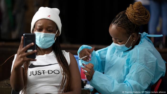 A young woman receives a COVID-19 vaccination in South Africa.