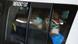 South Africans sit wearing masks in the back of a taxi South Africans sit wearing masks in the back of a taxi