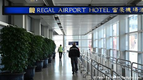 People head towards the Regal Airport Hotel at Chek Lap Kok airport in Hong Kong