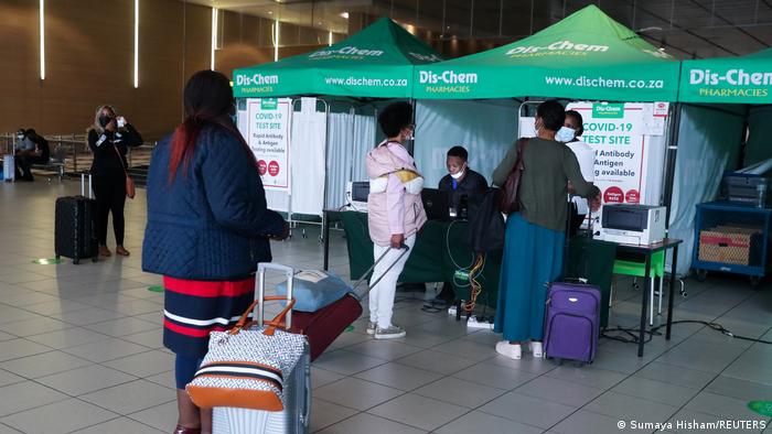 People with trolley suitcases line up outside PCR testing facility at Johannesburg airport