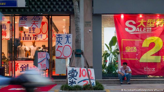 Discount signs at a clothing store in Haian city of Nantong