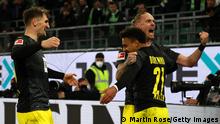 WOLFSBURG, GERMANY - NOVEMBER 27: Donyell Malen of Borussia Dortmund celebrates with teammates Thomas Meunier and Marius Wolf after scoring his team's second goal during the Bundesliga match between VfL Wolfsburg and Borussia Dortmund at Volkswagen Arena on November 27, 2021 in Wolfsburg, Germany. (Photo by Martin Rose/Getty Images)