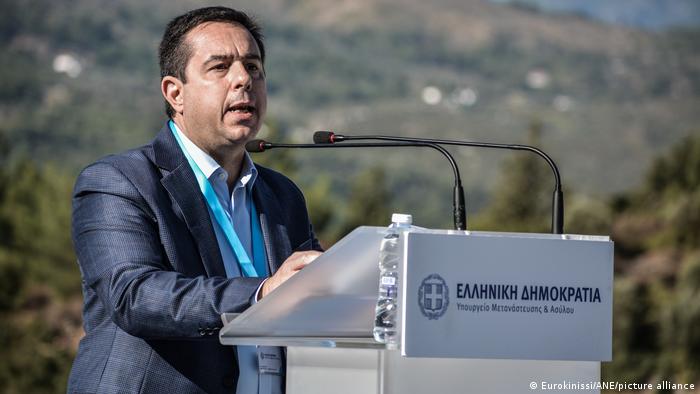 Greek Migration Minister Notis Mitarachi speaking at a podium