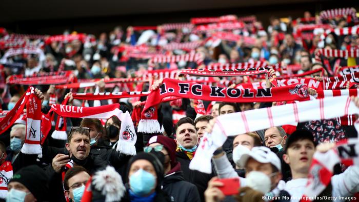 Cologne fans hold up scarves ahead of a game against Borussia Mönchengladbach