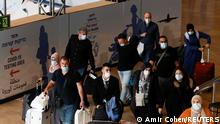 28.11.21 *** Travellers walk towards the coronavirus disease (COVID-19) pandemic testing area at Ben Gurion International Airport as Israel imposes new restrictions near Tel Aviv, Israel November 28, 2021. REUTERS/Amir Cohen