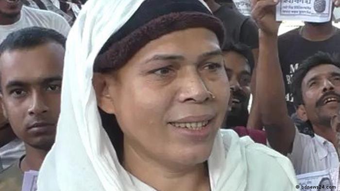Nazrul Islam Ritu with a slight smile, wearing a white and black headscarf