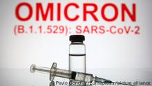 November 26, 2021, Ukraine: In this photo illustration, a medical syringe and a vial are seen in front of the text Omicron (B.1.1.529): SARS-CoV-2 in the background. (Credit Image: © Pavlo Gonchar/SOPA Images via ZUMA Press Wire