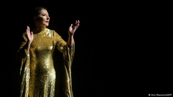 A still with Marina Abramovic dressed in a golden gown like Maria Callas.