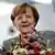Angela Merkel holding a bunch of flowers, smiling