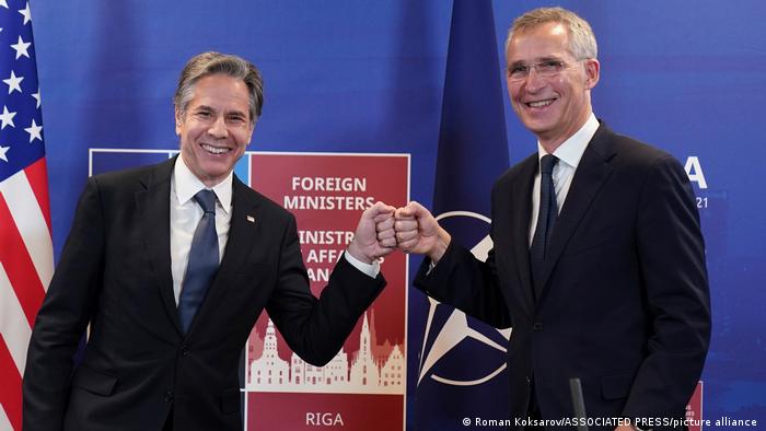 US Secretary of State Antony Blinken bumps fists with NATO chief Jens Stoltenberg