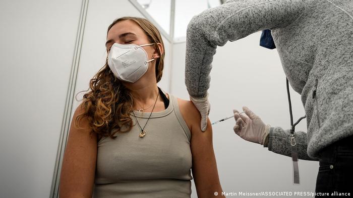 A woman gets her COVID vaccination