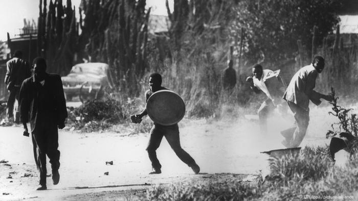 Young men take cover during this archive image of the 1976 Soweto Uprising