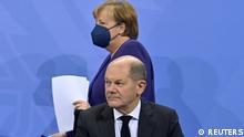 German Chancellor Angela Merkel arrives to address, together with her designated successor Olaf Scholz, a news conference following a meeting with the heads of government of Germany's federal states at the Chancellery in Berlin, Germany December 2, 2021 on measures to be taken to curb COVID-19 pandemic. John Macdougall/Pool via REUTERS