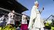 Pope Francis holds a wooden cross during a mass at a sports stadium Pope Francis holds a wooden cross during a mass at a sports stadium