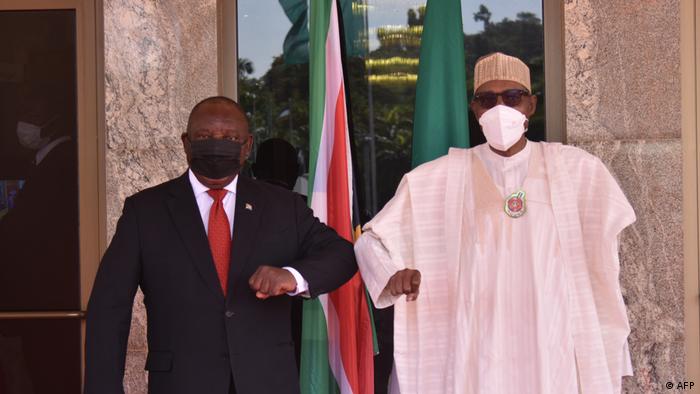 Cyril Ramaphosa and Mohammadu Buhari in Abuja bumping elbows, wearing face masks