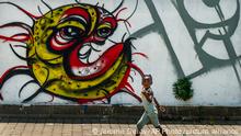 A child walks past a COVID-19 graffiti in Soweto's Orlando West township near Johannesburg, South Africa, Thursday Nov. 19, 2020. Africa has surpassed 2 million confirmed coronavirus cases as the continent's top public health official warns that “we are inevitably edging toward a second wave” of infections. The 54-nation continent of 1.3 billion people is being warned against “prevention fatigue” as countries loosen pandemic restrictions to ease their economies’ suffering and more people travel. (AP Photo/Jerome Delay)