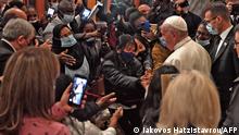 Pope Francis greets people during an ecumenical prayer with migrants at the Roman Catholic church of the Holy Cross near the United Nations buffer zone in the Cypriot city of Nicosia, Europe's last divided capital, on December 3, 2021. - Pope Francis appealed for a sense of fraternity in an open-air mass in Cyprus on Friday, the second day of a visit to the divided Mediterranean island that has focused heavily on the plight of migrants. (Photo by Iakovos HATZISTAVROU / AFP)