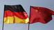 The German and Chinese flags side by side The German and Chinese flags side by side