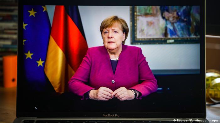 German Chancellor Angela Merkel appears on a screen in her final video podcast