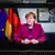 German Chancellor Angela Merkel appears on a screen in her final video podcast