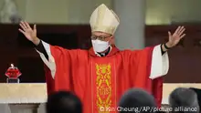 Stephen Chow waves at the episcopal ordination ceremony as the new Bishop of the Catholic Diocese, in Hong Kong, Saturday, Dec. 4, 2021. The new head of Hong Kong's Catholic diocese expressed hope Saturday that he could foster healing in a congregation and a city divided by the continuing fallout from massive anti-government protests in 2019. (AP Photo/Kin Cheung)
